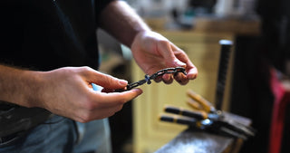 Person holding a bracelet in a workshop setting